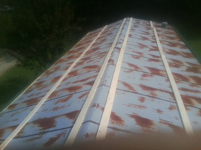 Rusted metal roof panels with new wood purlins before replacement — Storm Damage Roof Repair in Mary D by Roofing Brothers