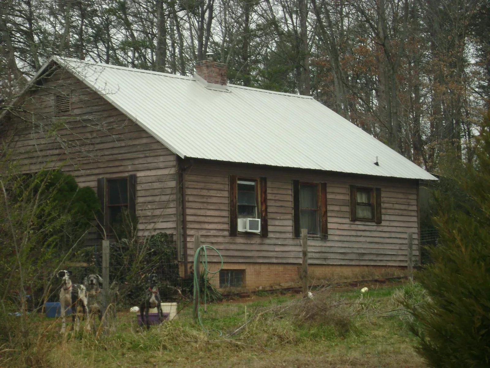 White metal roof on an old wood sided farmhouse, from a Metal Roof Installation job in Mary D